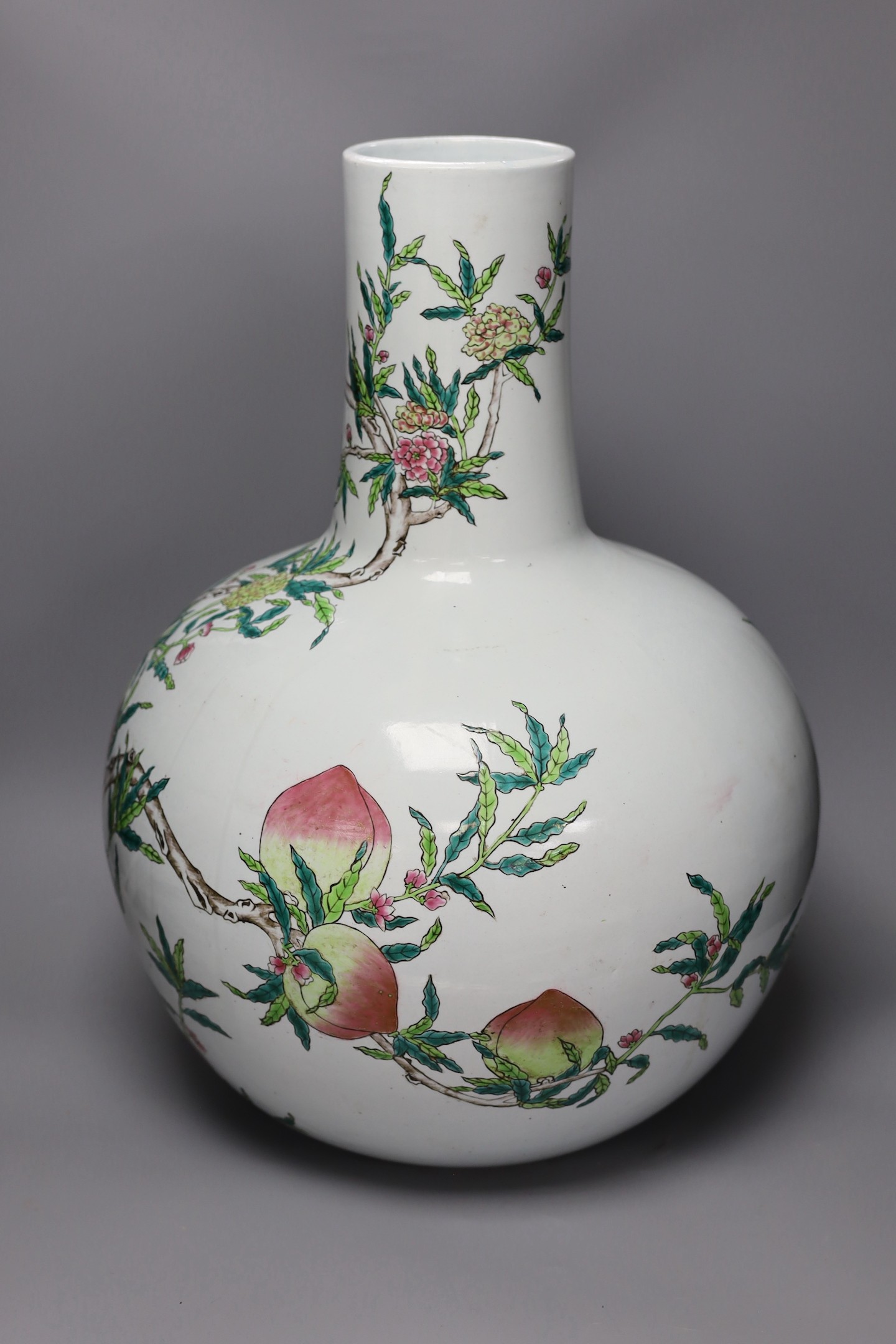 A large Chinese famille rose ‘nine peach’ bottle vase, 58cms high